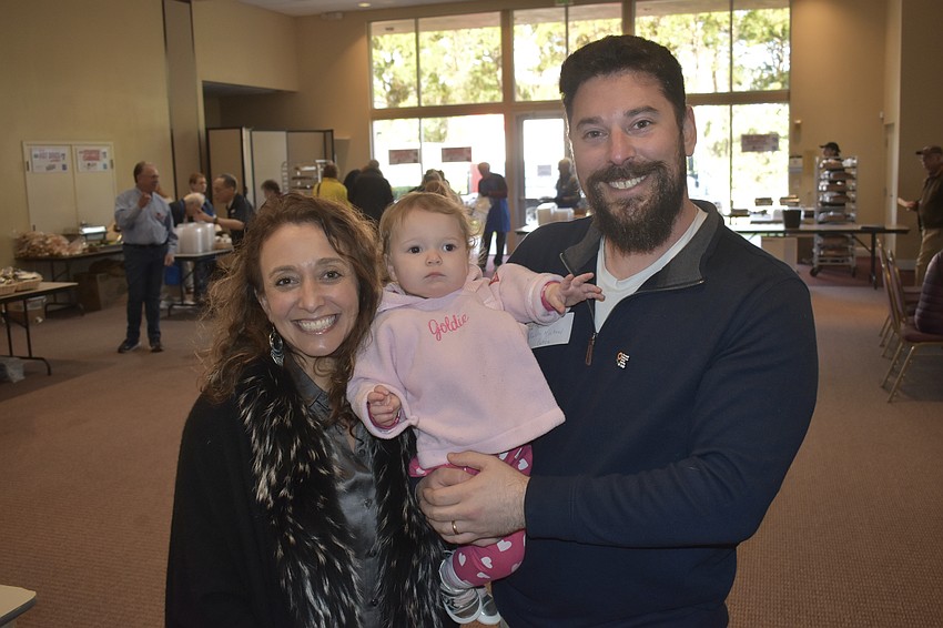 Rabbi Michael Cohen (right), his wife Sharon Poczter, an economist and professor at Yeshiva University, and their daughter Golda Cohen, 1, joined members and attendees at the event.