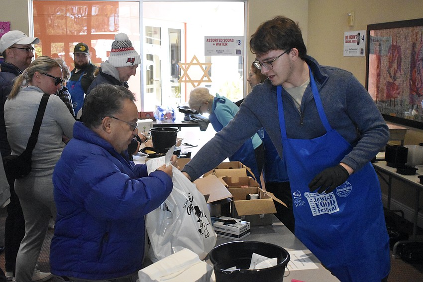 Abe Lederman accepts an item from Ben Yodfat.