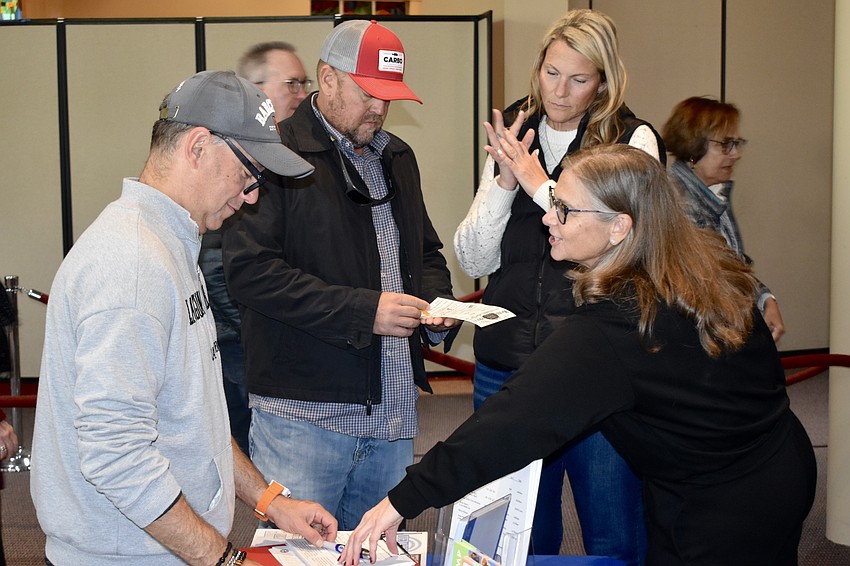 Igor Barmash, Kevin Feaster, Erin NesSmith and Lauren Cohen interact at a table.