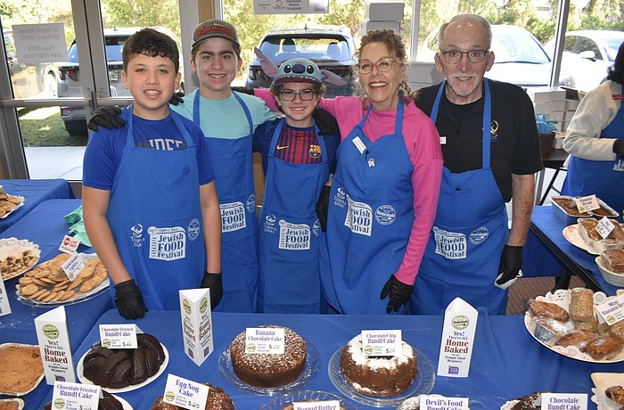 Ethan Freeman, 14, Skate Segal, 14, Jett Segal, 12, Florey Miller and her husband TJ Miller were among those serving foods baked by members.