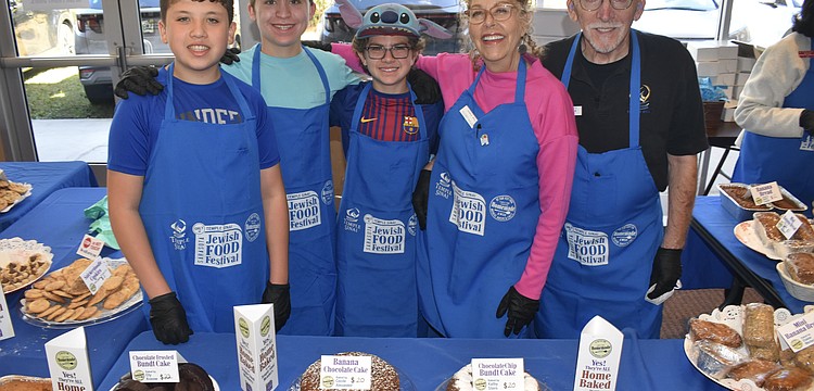 Ethan Freeman, 14, Skate Segal, 14, Jett Segal, 12, Florey Miller and her husband TJ Miller were among those serving foods baked by members.