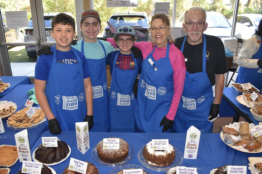 Ethan Freeman, 14, Skate Segal, 14, Jett Segal, 12, Florey Miller and her husband TJ Miller were among those serving foods baked by members.
