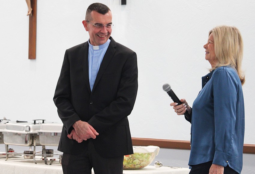 St. Mary, Star of the Sea, Catholic Church Father Robert Dziedziak and Women's Guild President Kay Kochenderfer share a laugh at the beginning of the new members' luncheon.