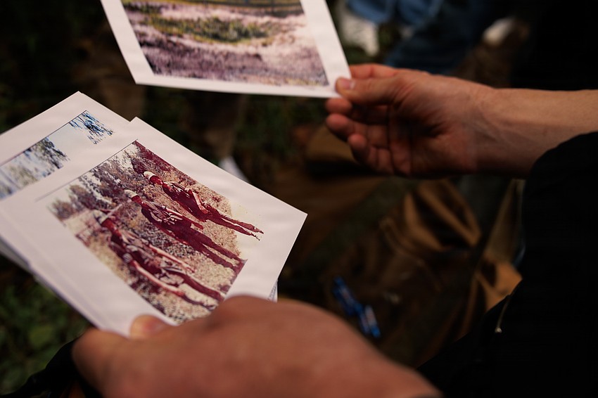 U.S. Marines and Sailors with the 31st Marine Expeditionary Unit, look at historical photos during a tour of the battlefield in the Quế Sơn Valley.