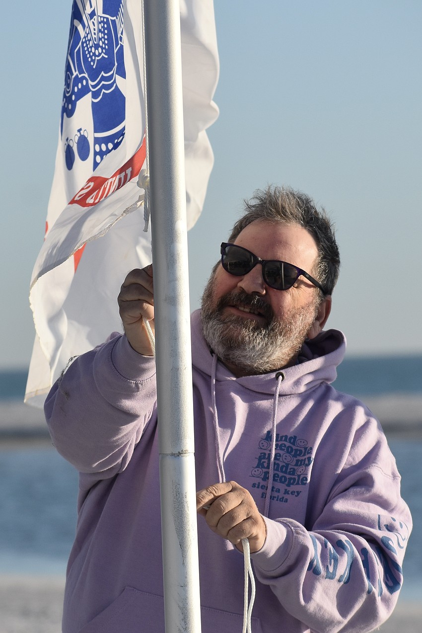 Wayne Bundy attaches the Army flag.