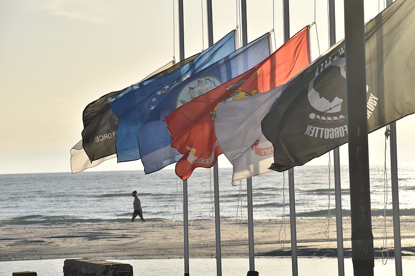 The flags fly on the new poles.