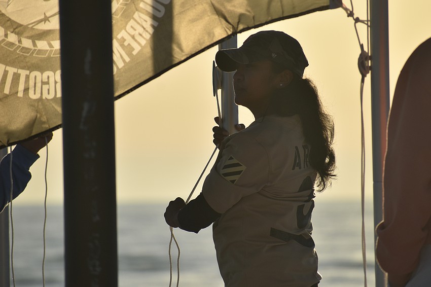 Maria Guardado-Villagran raises the Army flag.