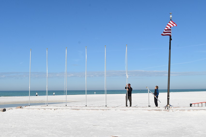 Tom and Robyn Modly install the flagpoles.