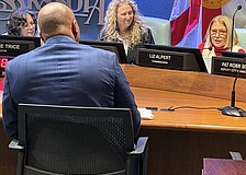 Commisisoner Liz Alpert (right) questions Parks and Recreation Director Jerry Fogle during the hearing about the Bobby Jones clubhouse design as Commissioner Jen Ahearn-Koch looks on.