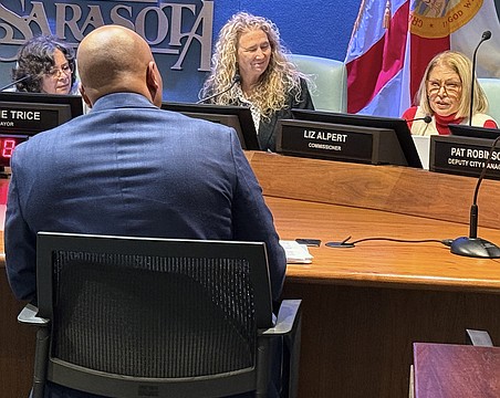 Commisisoner Liz Alpert (right) questions Parks and Recreation Director Jerry Fogle during the hearing about the Bobby Jones clubhouse design as Commissioner Jen Ahearn-Koch looks on.