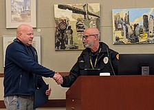 Longboat Key Police Department Customer Service Specialist Ivan Zunz shakes hands with Police Chief Russ Mager at a Town Commission meeting Monday, Feb. 2. Zunz was recognized for 10 years with LKPD at the meeting.