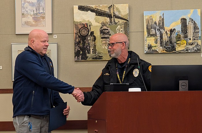 Longboat Key Police Department Customer Service Specialist Ivan Zunz shakes hands with Police Chief Russ Mager at a Town Commission meeting Monday, Feb. 2. Zunz was recognized for 10 years with LKPD at the meeting.