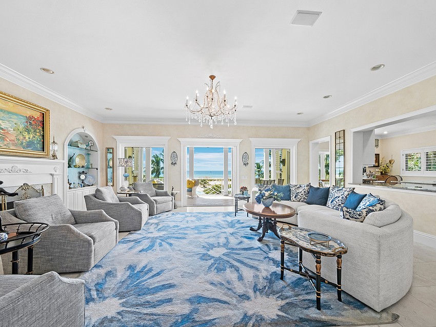 The expansive living room has a traditional flair, with colors that bring the outdoors in.