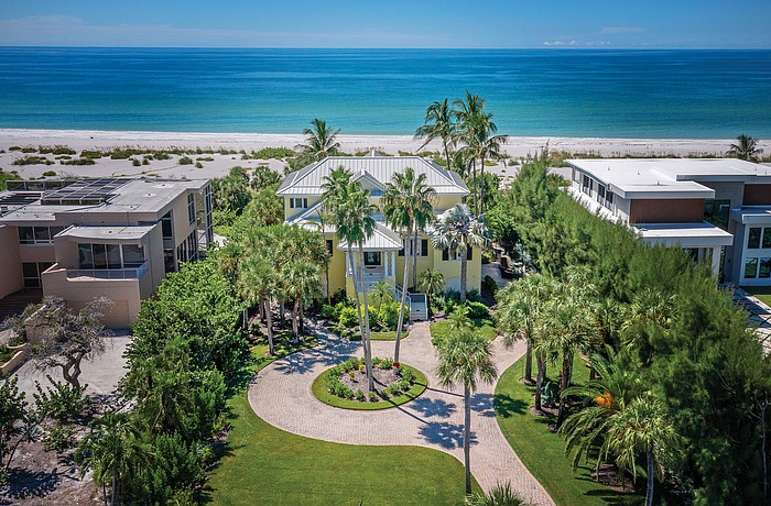Palm trees and a white sand beach provide a classic tropical setting.