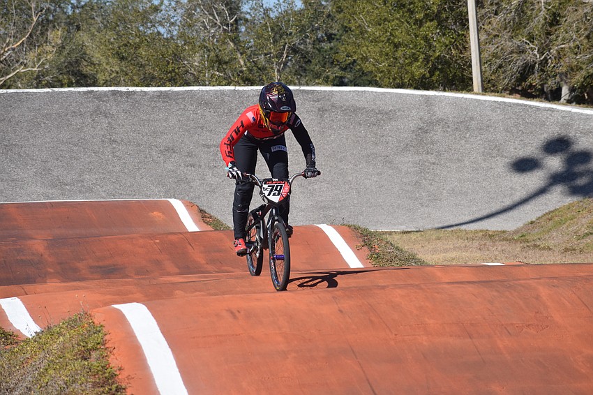 Carly Kane of Indiana heads toward the finish line during practice at Sarasota BMX.