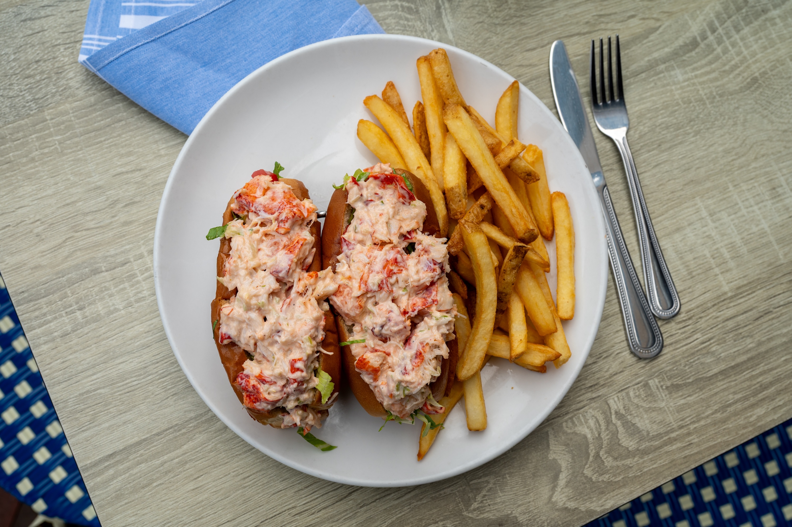 Dry Dock Waterfront Grill’s chilled lobster rolls, packed with knuckle and claw meat and served with golden fries.