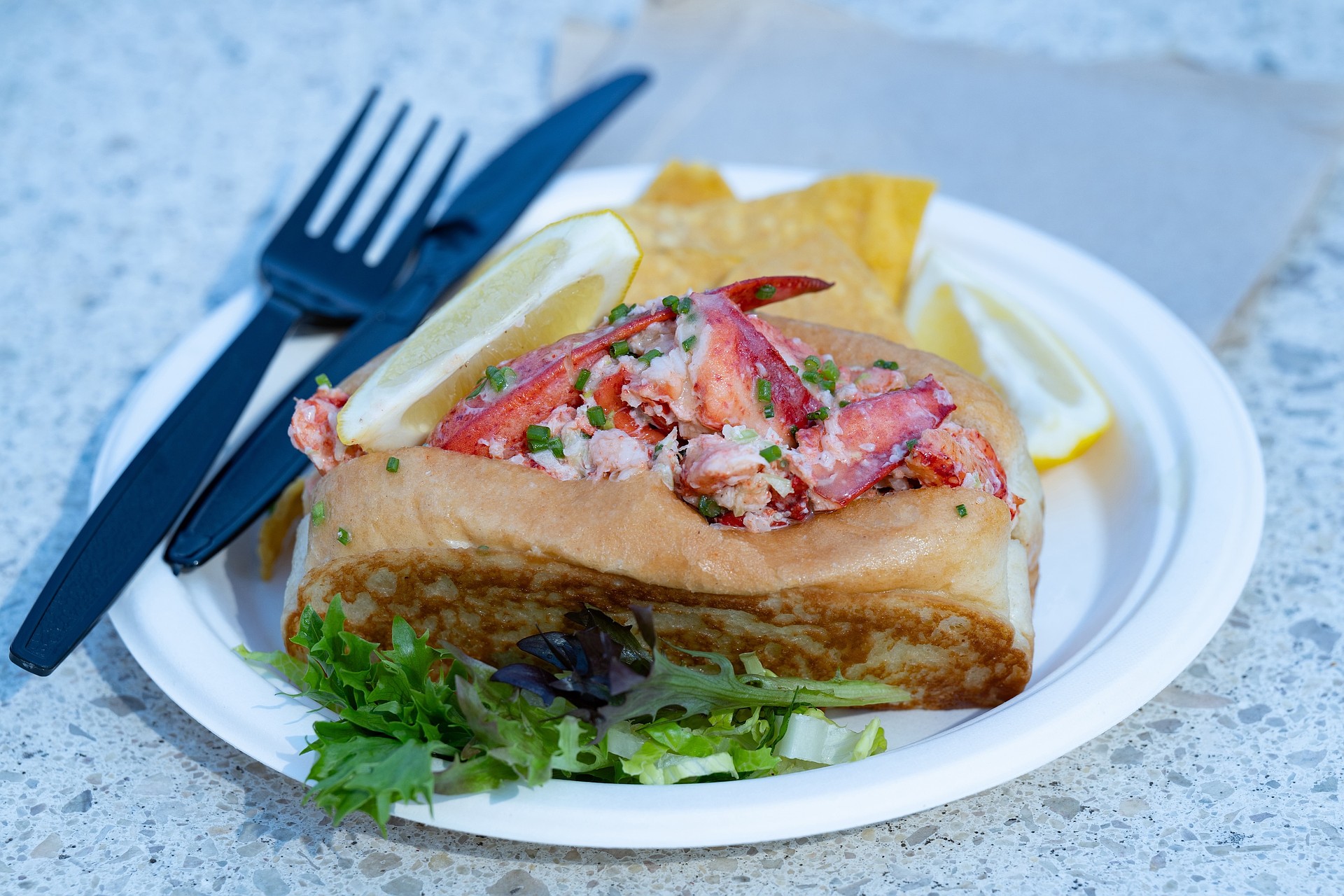 Lido Island Grill's lobster roll, filled with chilled Maine lobster and served with tortilla chips and lemon.