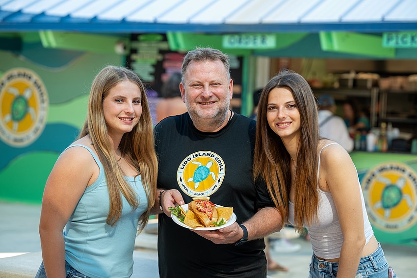 Blanka, Laszlo and Csenge Bevardi with Lido Island Grill’s signature lobster roll.