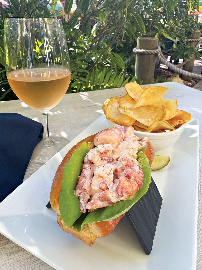 Chilled Maine lobster, lightly dressed and nestled in a buttered, toasted split-top bun, served with hot, house-made potato chips and a glass of rosé — simple, classic and quintessentially Longboat Key.