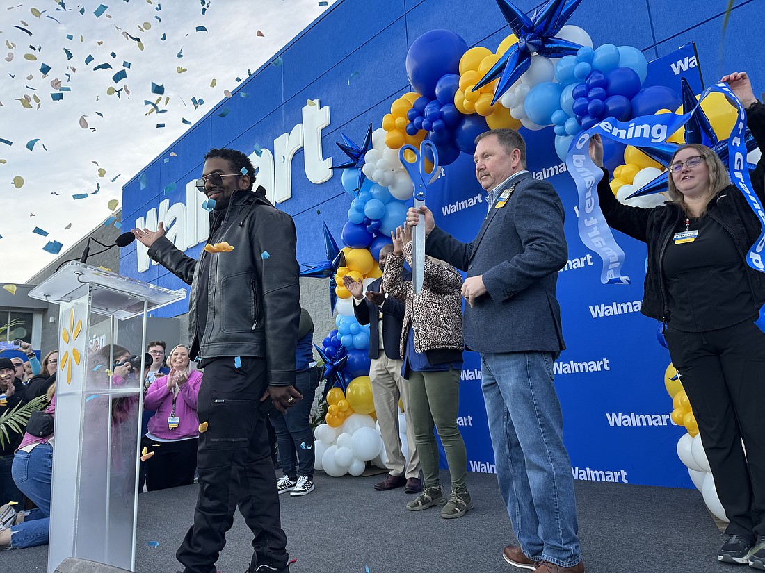 Walmart cut the ribbon Feb. 4 on its new Supercenter at 10000 Omni Drive near Oakleaf Plantation. Holding the scissors is store manager Brian Jackson. The event was to include a meet-and-greet with former Jacksonville Jaguars running back Fred Taylor and entertainment from saxophonist, rapper, DJ and producer D-Nice.