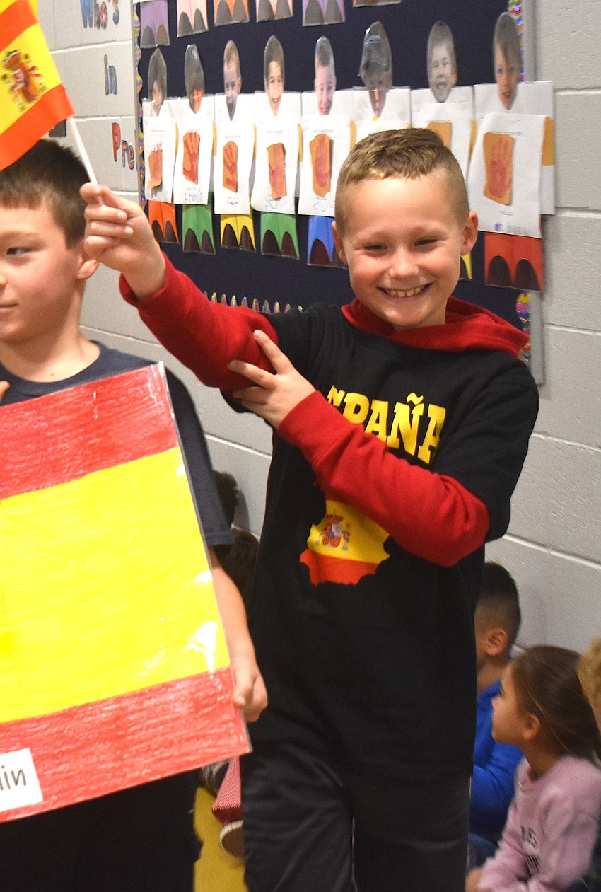 Grayson Greubel, a third grader at Tara Elementary School, waves a small flag of Spain.