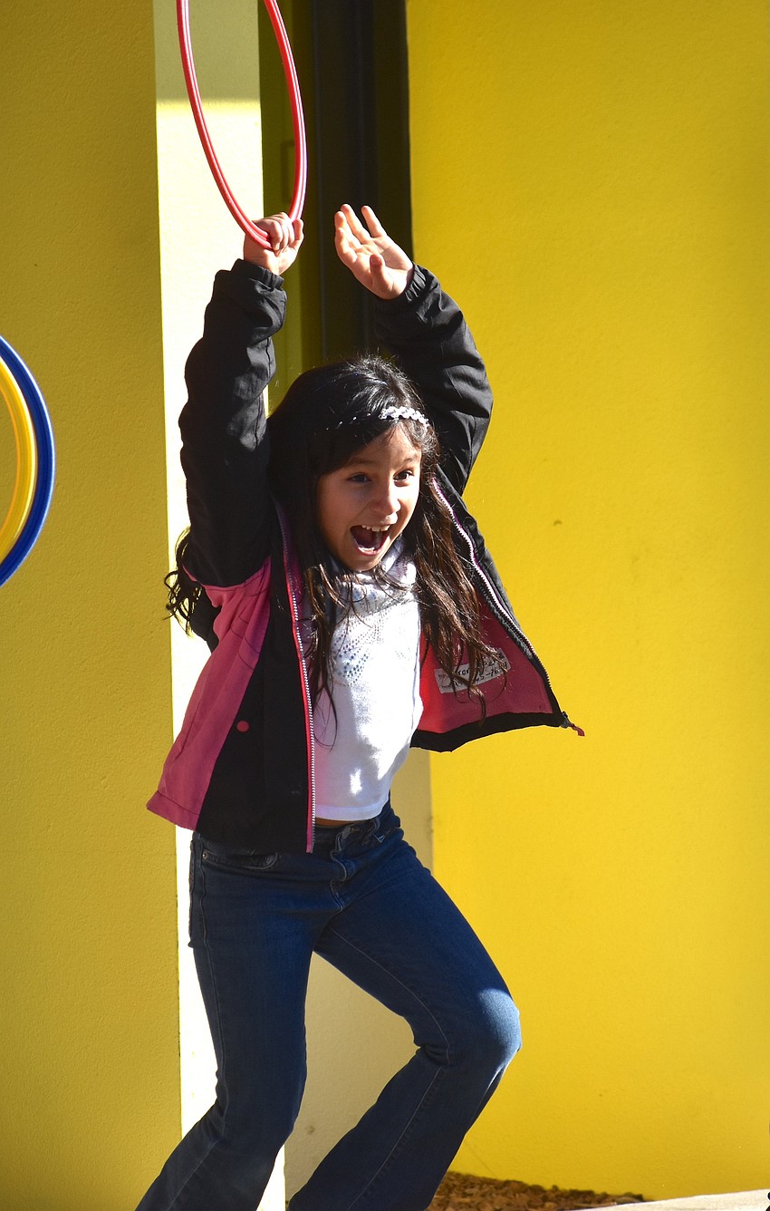 Aurora Pena, a second grader at Tara Elementary, eagerly waits for the game of Olympic Torch and Ring Freeze Tag to begin.