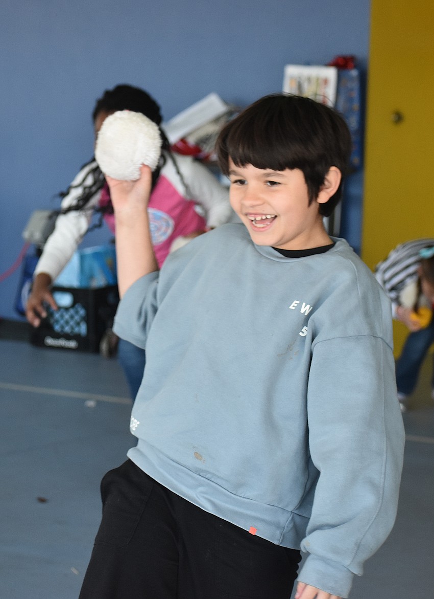 Kevin Parra, a second grader at Tara Elementary, makes sure to throw as many snowballs as possible in the game of Snowball Toss.