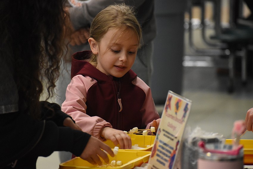 Kindergartener Payton Bieniasz engineers a structure.