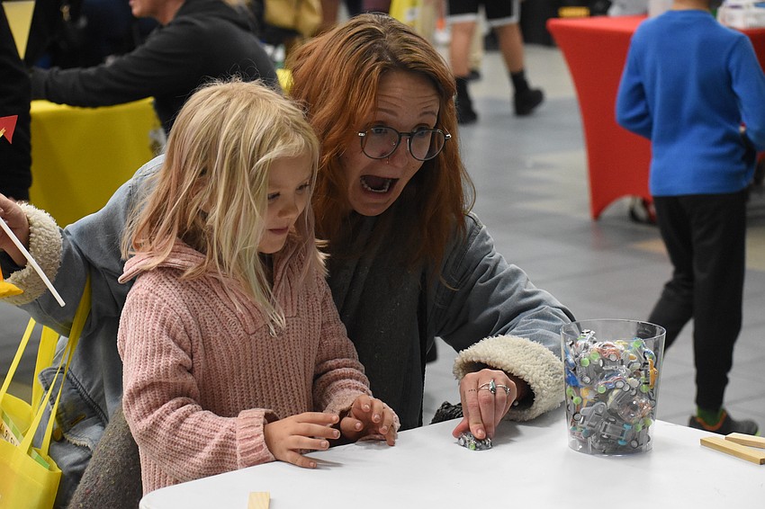 PJ Tumpkin, 5, and Devin Tumpkin help some toy cars to unleash their energy.