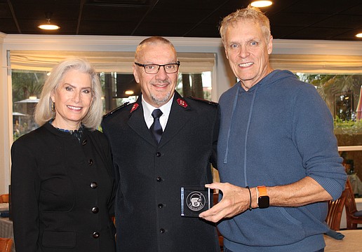 Kiwanis Club of Longboat Key President Danielle Gladding, Salvation Army Capt. Jim Curry and bellringing coordinator Chris Sachs, a former club president, celebrate a stand-out year for donations.