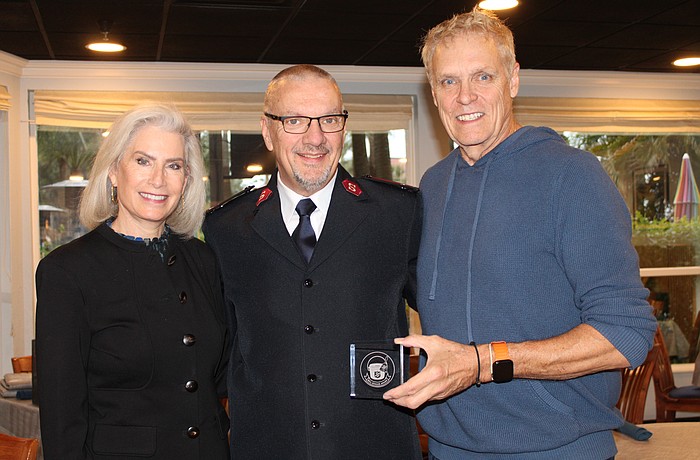 Kiwanis Club of Longboat Key President Danielle Gladding, Salvation Army Capt. Jim Curry and bellringing coordinator Chris Sachs, a former club president, celebrate a stand-out year for donations.