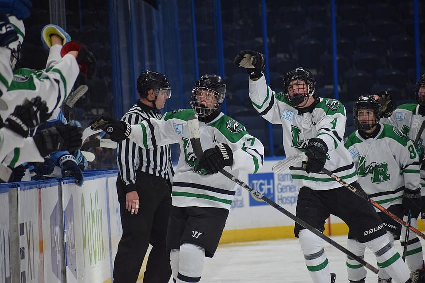 The Mustangs head toward their bench and form a high-five line. Powered by a four-goal third period, they handed the Wolves their third loss all season.