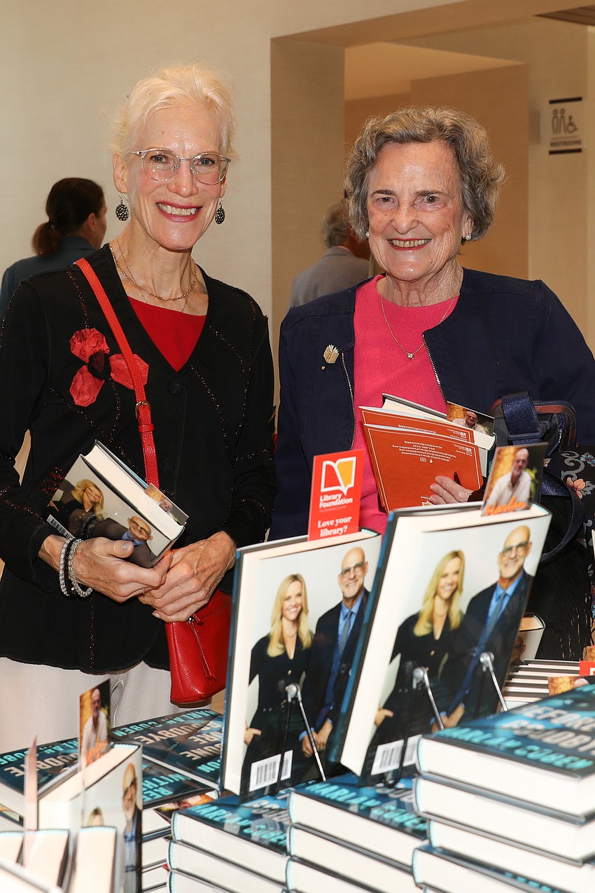 Margaret Levinson and Eleanor Odden pick up their copies of 