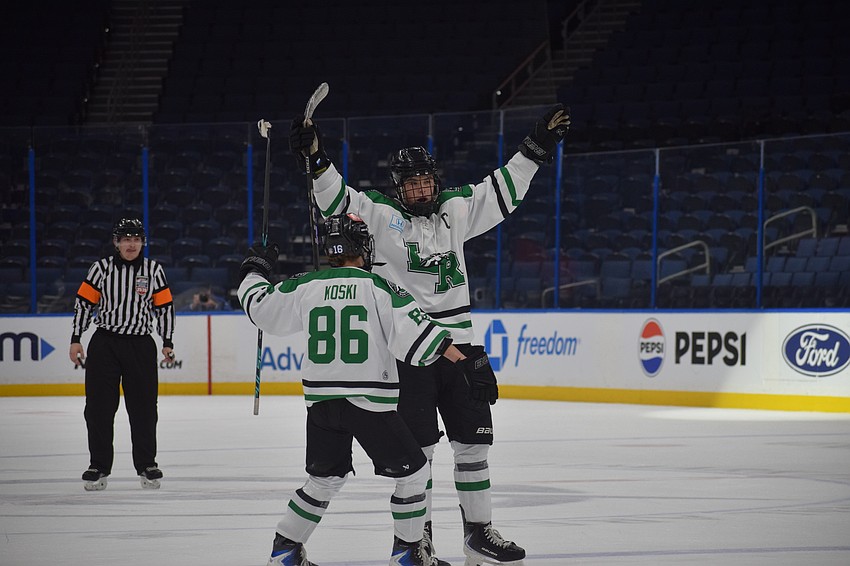 Chase Koski (86) and Jackson Ellis (4) celebrate a Mustangs goal in the second period. They both rank among the team's top three in points.