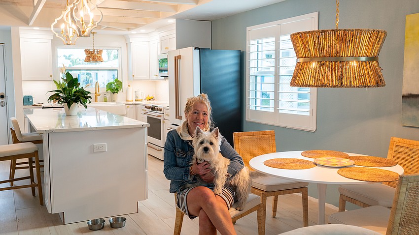 Amanda Boe and her dog Shipley recently moved into their Spanish Main villa. Boe, with years of experience in real estate, morphed the interior to her taste after buying the house in a gutted state with lower cabinets and drywall removed.