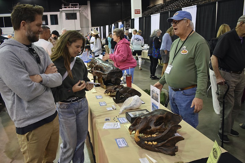 John and Kerry Jacobs talk with John Jacobs, who is representing the Tampa Bay Fossil Club.