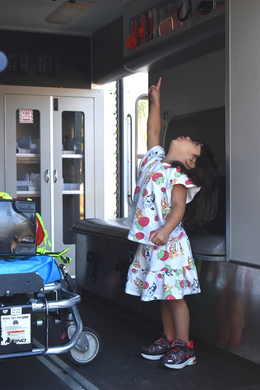 Greenbrook's Josephina Ferda, 3, points up at the ceiling of the Search and Rescue truck and shouts 