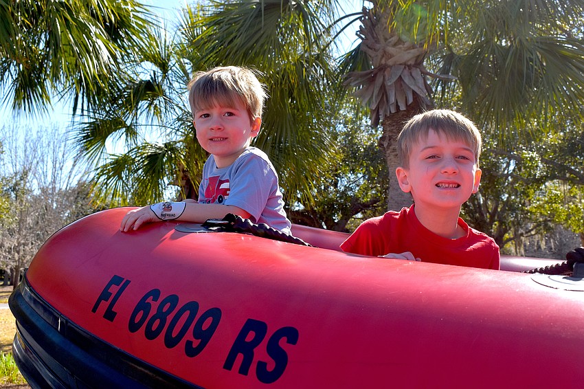 Braden Woods' Mason Eibe, 3, and Archer Eibe, 6, take a seat on the Manatee County Search and Rescue boat.