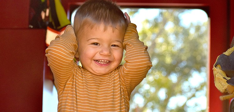 Lakehouse Cove's 16-month-old Hunter Colon shows his excitement to be inside a fire truck at the Celebrate Our First Responders event Feb. 7 at the Greenbrook Adventure Park.