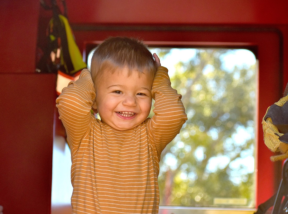 Lakehouse Cove's 16-month-old Hunter Colon shows his excitement to be inside a fire truck at the Celebrate Our First Responders event Feb. 7 at the Greenbrook Adventure Park.