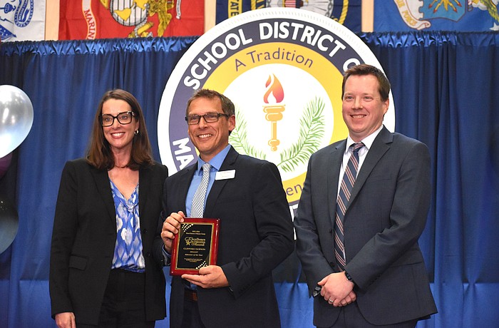 The School District of Manatee County's Superintendent Laurie Breslin, Educator of the Year Clifford Dawson and Deputy Superintendent of Instructional Services Derek Jensen pose for a photo at the Excellence in Education Awards on Feb. 4.