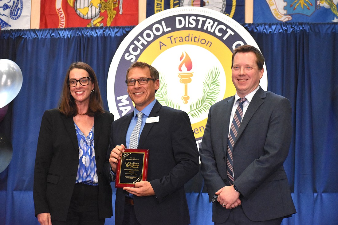 The School District of Manatee County's Superintendent Laurie Breslin, Educator of the Year Clifford Dawson and Deputy Superintendent of Instructional Services Derek Jensen pose for a photo at the Excellence in Education Awards on Feb. 4.