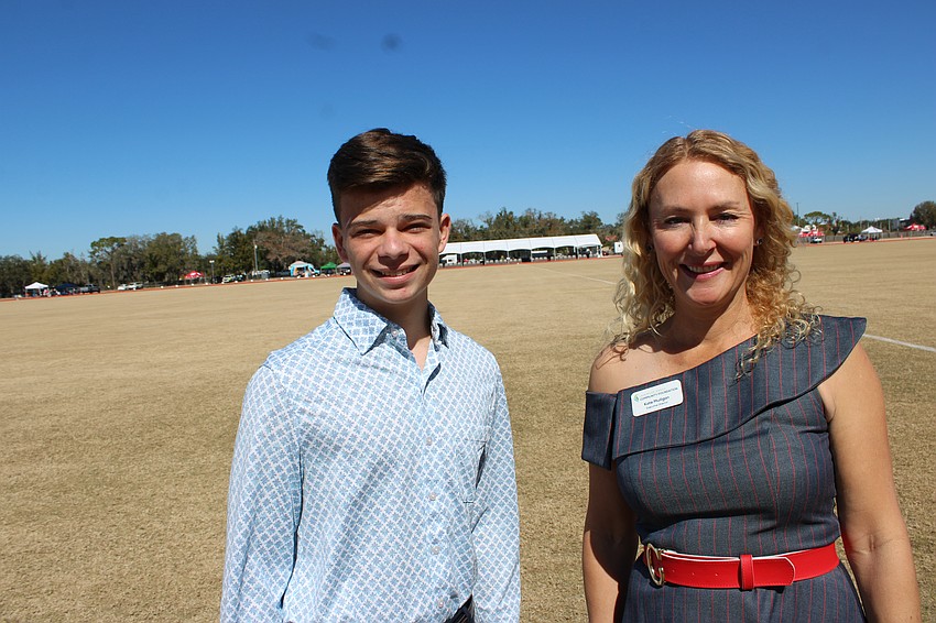 Junior Humanitarian Award winner Tom Bergerat visits with Lakewood Ranch Community Foundation Executive Director Kate Mulligan at the Sarasota Polo Club Feb. 7