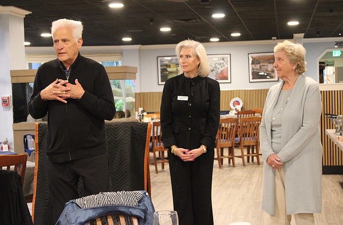 Frank Martucci, joined by Kiwanis Club of Longboat Key President Danielle Gladding and his wife, Katherine Martucci, explains what compelled him to give back his 50/50 raffle winnings from the Lawn Party to support the Children's Guardian Fund.