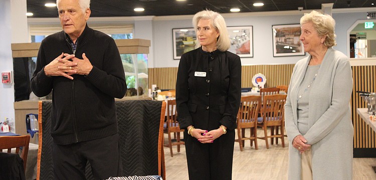 Frank Martucci, joined by Kiwanis Club of Longboat Key President Danielle Gladding and his wife, Katherine Martucci, explains what compelled him to give back his 50/50 raffle winnings from the Lawn Party to support the Children's Guardian Fund.