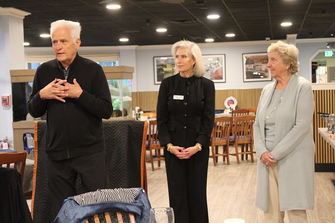 Frank Martucci, joined by Kiwanis Club of Longboat Key President Danielle Gladding and his wife, Katherine Martucci, explains what compelled him to give back his 50/50 raffle winnings from the Lawn Party to support the Children's Guardian Fund.