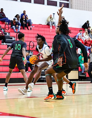 Seabreeze's Jeremiah Outler (0) drives in traffic in a game against Orlando Jones on Feb. 5. Photo by Keishia McLendon