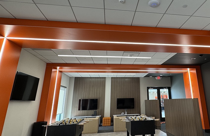 The orange-accented player lounge features foosball and ping-pong tables. 