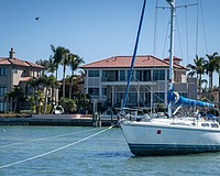 Tipsea Gypsea, a 45-foot Catalina sailboat, lies beached on a sandbar near the Harbor Acres neighborhood, posing a risk to the neighborhood’s seawall and dozens of nearby moored boats. Sarasota Police Department Marine Patrol Officer Michael Skinner said the registered owner is working to get a specialized bolt to re-attach the steering wheel.