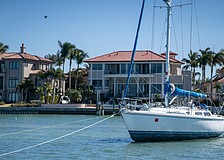 Tipsea Gypsea, a 45-foot Catalina sailboat, lies beached on a sandbar near the Harbor Acres neighborhood, posing a risk to the neighborhood’s seawall and dozens of nearby moored boats. Sarasota Police Department Marine Patrol Officer Michael Skinner said the registered owner is working to get a specialized bolt to re-attach the steering wheel.